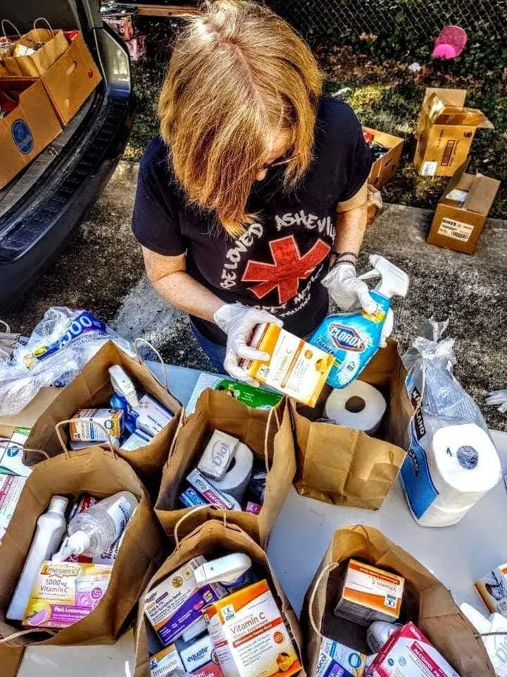 Someone putting together releif supplies into paper bags